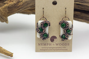 Handmade earring with white and dark green fused glass and copper wire wrapping