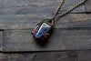 Black and Streaked Blue Glass Pendant with Copper Wire Wrapping