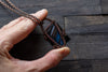 Black and Streaked Blue Glass Pendant with Copper Wire Wrapping