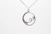 handmade circular pendant with sterling silver wire wrapping