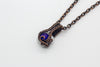 Small handmade pendant with blue and white fused glass and copper wire wrapping