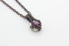 Small handmade pendant with purple and white fused glass and copper wire wrapping