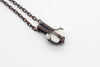 Small handmade pendant with purple and white fused glass and copper wire wrapping