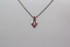 Small handmade pendant with purple and white fused glass and copper wire wrapping