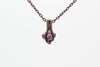 Small handmade pendant with purple and white fused glass and copper wire wrapping