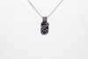 elegant handmade pendant with black fused glass and sterling silver wire wrapping