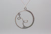 Handmade circular sterling silver wire wrapped pendant
