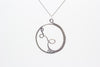 Handmade circular sterling silver wire wrapped pendant