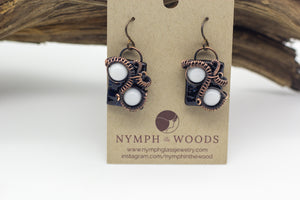 handmade white and dark blue fused glass earrings with copper wire wrapping from Nymph in the Woods
