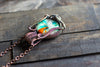 Copper Wire Wrapped Pendant with Blue-green and Orange Glass