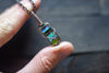 Streaked Green and Blue Fused Glass and Copper Wire Crisscross Pendant