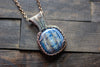 Copper Wire Wrapped Pendant with Snowflake on Streaked Blue Fused Glass